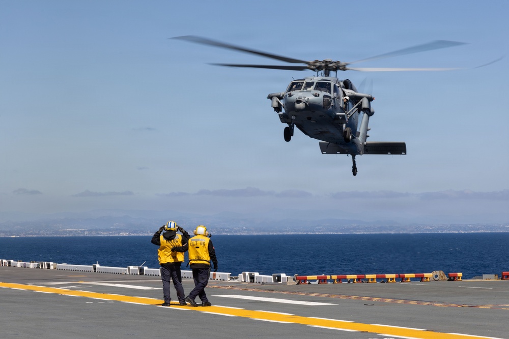 MV-22B Ospreys and MH-60 Seahawk execute embarking procedures on USS Makin Island