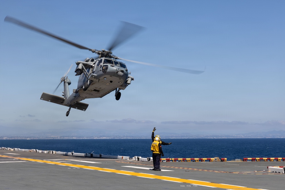 MV-22B Ospreys and MH-60 Seahawk execute embarking procedures on USS Makin Island