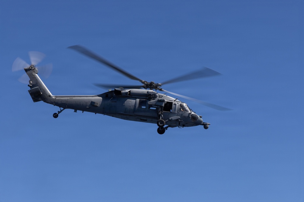 MV-22B Ospreys and MH-60 Seahawk execute embarking procedures on USS Makin Island