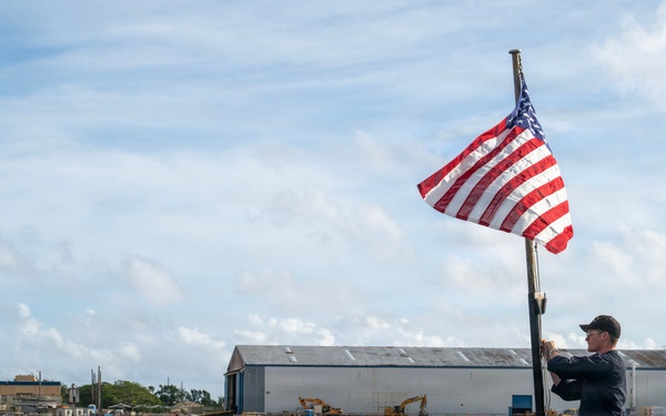 Retired U.S. Navy Cmdr. Allan Rigggs participates in morning colors aboard USS Annapolis