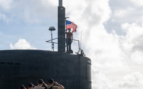 Retired U.S. Navy Cmdr. Allan Rigggs participates in morning colors aboard USS Annapolis