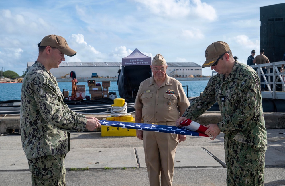 Retired U.S. Navy Cmdr. Allan Rigggs participates in morning colors aboard USS Annapolis