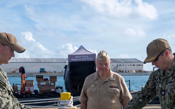 Retired U.S. Navy Cmdr. Allan Rigggs participates in morning colors aboard USS Annapolis