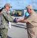 Retired U.S. Navy Cmdr. Allan Rigggs participates in morning colors aboard USS Annapolis