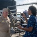 Retired U.S. Navy Cmdr. Allan Rigggs participates in morning colors aboard USS Annapolis