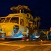 Sailors secure an MH-60R Seahawk helicopter, assigned to Helicopter Maritime Strike Squadron (HSM) 48, to the flight deck.