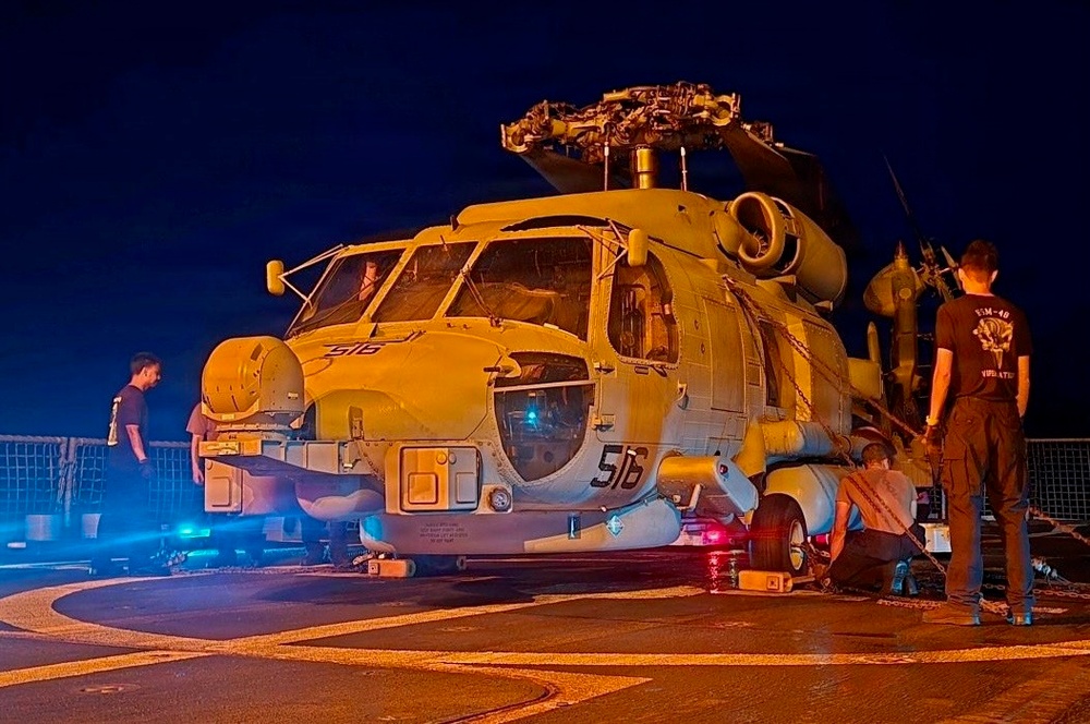 Sailors secure an MH-60R Seahawk helicopter, assigned to Helicopter Maritime Strike Squadron (HSM) 48.
