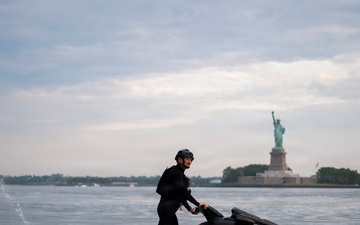 Coast Guard personal watercraft operates near Statue of Liberty during Sail 250