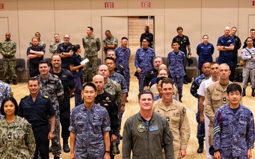 RIMPAC 2026 participants pose for photo during PHOTOEX brief for RIMPAC 2026