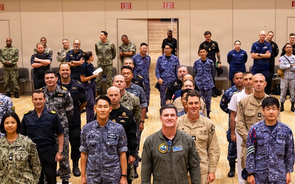 RIMPAC 2026 participants pose for photo during PHOTOEX brief for RIMPAC 2026
