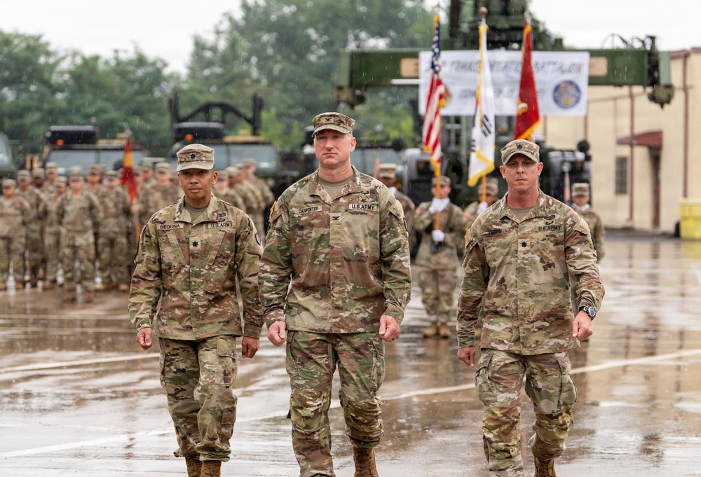 From left, Lt. Col. Dequina, outgoing commander; Col. R. Scott Carpenter, MSC‑K commander; and Lt. Col. Dixon, incoming commander, make their way back to their positions after the passing of the guidon during the 25th TB COC Ceremony.