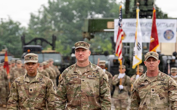 From left, Lt. Col. Dequina, outgoing commander; Col. R. Scott Carpenter, MSC‑K commander; and Lt. Col. Dixon, incoming commander, make their way back to their positions after the passing of the guidon during the 25th TB COC Ceremony.