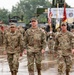 From left, Lt. Col. Dequina, outgoing commander; Col. R. Scott Carpenter, MSC‑K commander; and Lt. Col. Dixon, incoming commander, make their way back to their positions after the passing of the guidon during the 25th TB COC Ceremony.