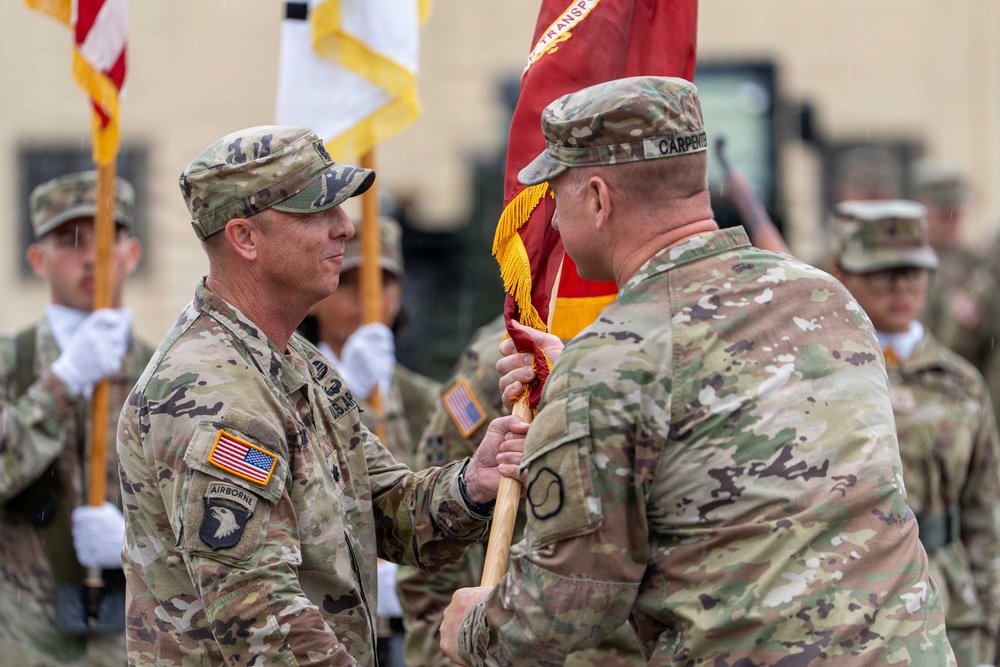 Lt. Col. Jeremy R. Dixon receives the guidon of the 25th Transportation Battalion (TB) from Col. R. Scott Carpenter, MSC‑K commander, during the 25th TB Change of Command Ceremony.