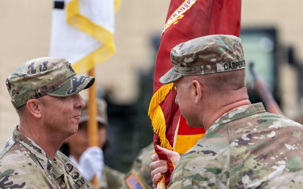 Lt. Col. Jeremy R. Dixon receives the guidon of the 25th Transportation Battalion (TB) from Col. R. Scott Carpenter, MSC‑K commander, during the 25th TB Change of Command Ceremony.