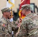 Lt. Col. Jeremy R. Dixon receives the guidon of the 25th Transportation Battalion (TB) from Col. R. Scott Carpenter, MSC‑K commander, during the 25th TB Change of Command Ceremony.