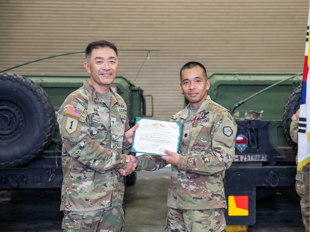 Lt. Col. Frederick T. Dequina poses for a photo with Brig. Gen. Jin H. Pak, 19th ESC commander, after receiving the Meritorious Service Medal.