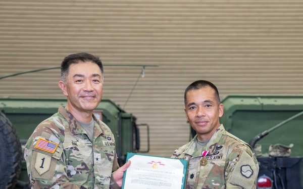 Lt. Col. Frederick T. Dequina poses for a photo with Brig. Gen. Jin H. Pak, 19th ESC commander, after receiving the Meritorious Service Medal.