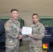 Lt. Col. Frederick T. Dequina poses for a photo with Brig. Gen. Jin H. Pak, 19th ESC commander, after receiving the Meritorious Service Medal.