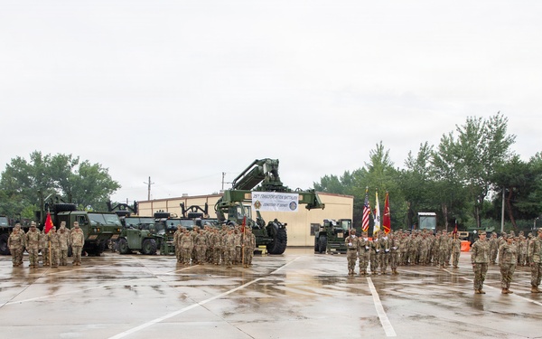 Soldiers of the 25th Transportation Battalion stand in formation for the Change of Command Ceremony at their motor pool.