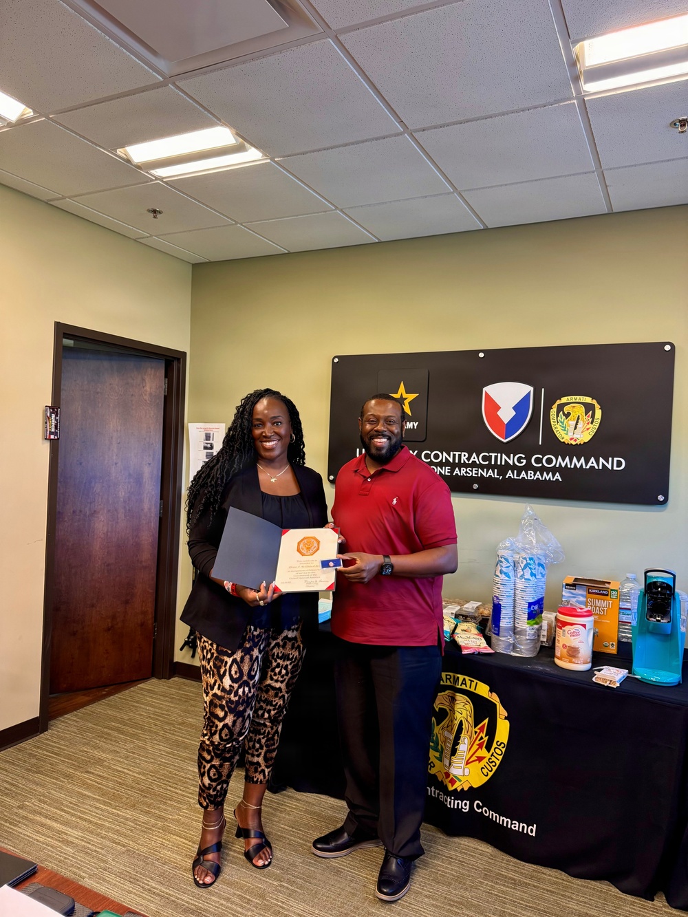 Ebonie McClintock-Bennett with her 15-year service certificate