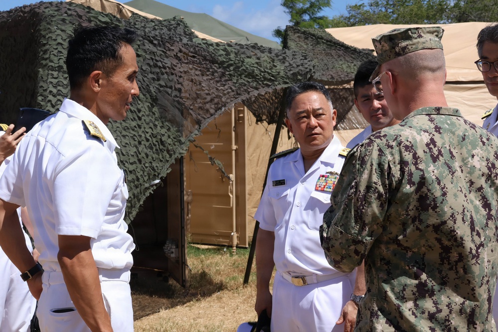 Japanese Maritime Self Defense Force personnel tour the RIMPAC 2026 humanitarian assistance and disaster relief camp