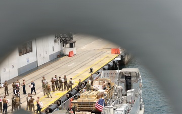 U.S. Marines, with 3rd Battalion, 2nd Marine Regiment, Littoral Combat Force-24, and U.S. Sailors, with San Antonio-class amphibious transport dock USS Fort Lauderdale (LPD 28), load supplies.