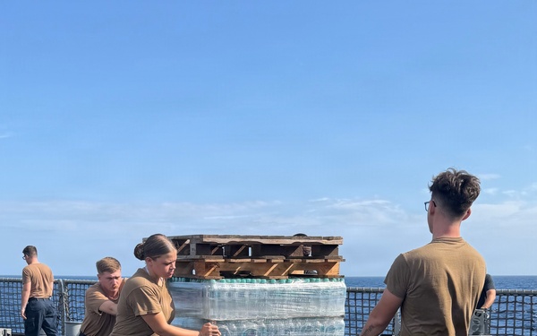 U.S. Navy Sailors stage water donated by the Netherlands for transfer aboard the littoral combat ship USS Billings (LCS 15) while underway off the coast of Venezuela, July 2, 2026.