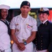 U.S. Navy Sailors pose with a British Royal Navy Sailor for a photo in Times Square in New York