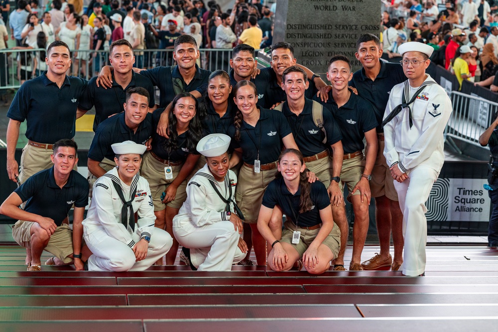 U.S. Navy Sailors pose with Allies and partners for a photo in Times Square in New York
