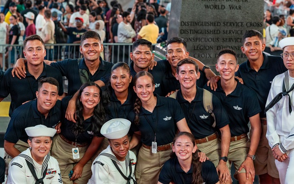 U.S. Navy Sailors pose with Allies and partners for a photo in Times Square in New York