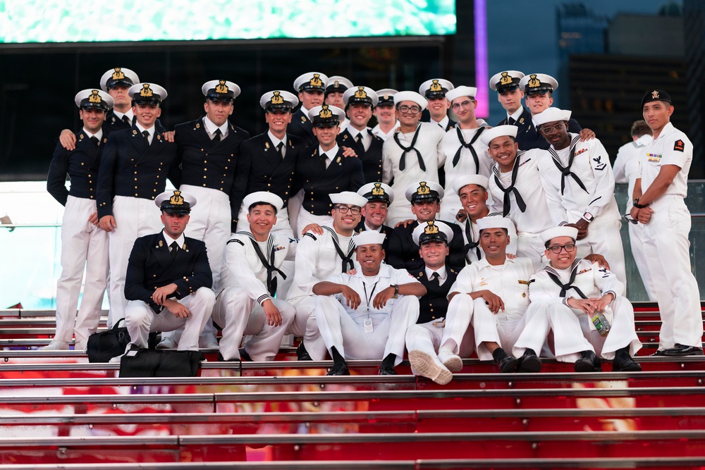 U.S. Navy Sailor pose with Royal British Navy Sailors for a photo on the iconic Red Steps in Times Square
