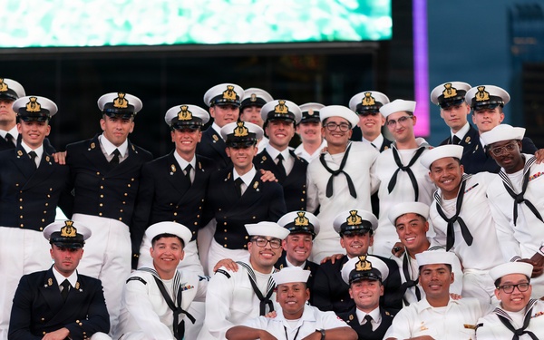 U.S. Navy Sailor pose with Royal British Navy Sailors for a photo on the iconic Red Steps in Times Square