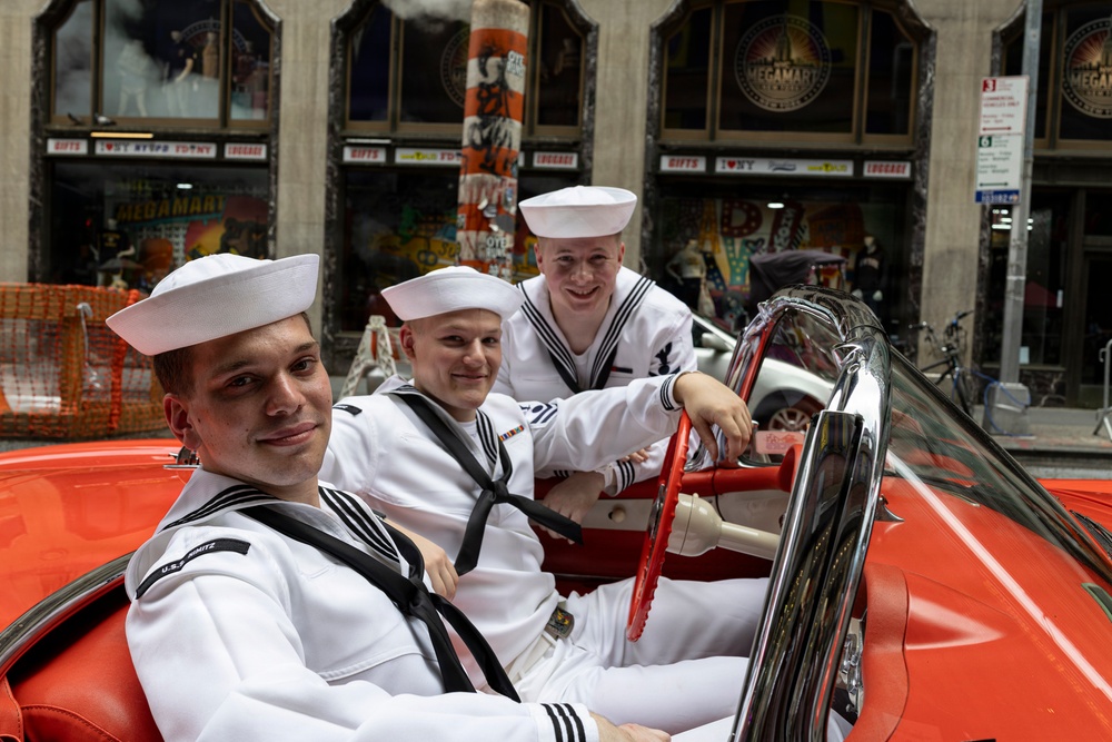 U.S. Sailors pose in a car near Times Square during International Naval Review 250, New York,