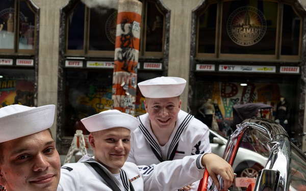 U.S. Sailors pose in a car near Times Square during International Naval Review 250, New York,