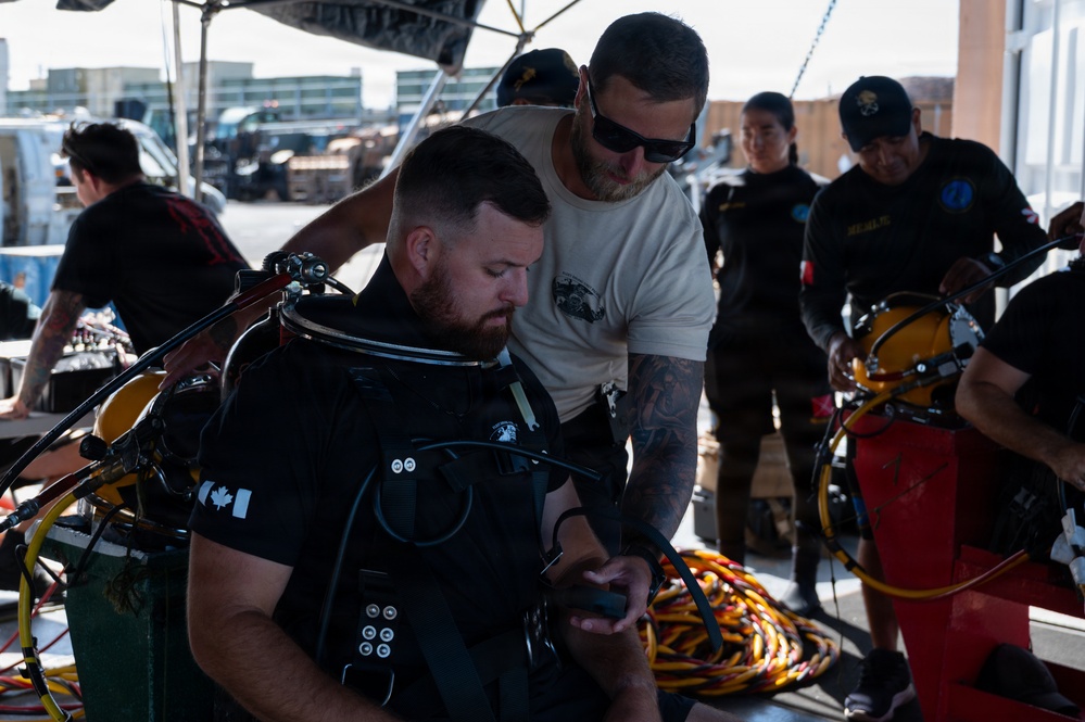 Multinational Clearance Divers conduct a wreck access cutting dive during RIMPAC 2026