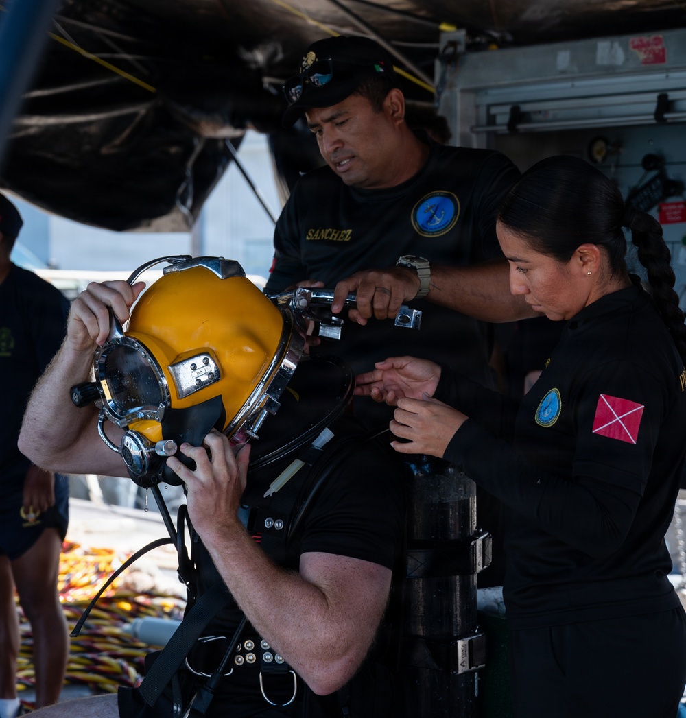 Multinational Clearance Divers conduct a wreck access cutting dive during RIMPAC 2026