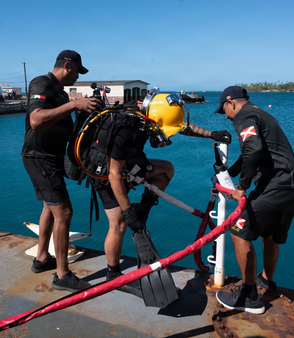 Multinational Clearance Divers conduct a wreck access cutting dive during RIMPAC 2026