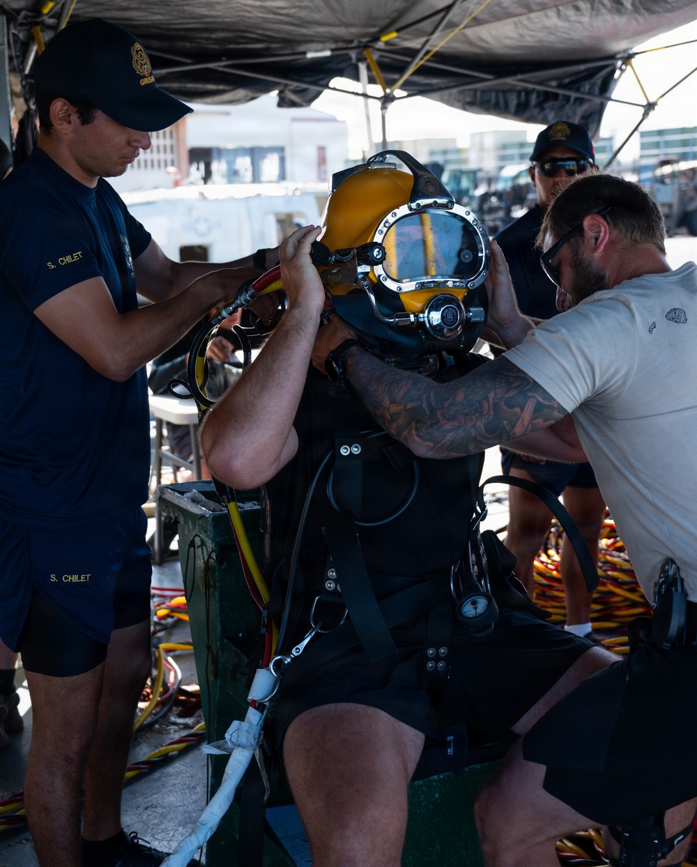 Multinational Clearance Divers conduct a wreck access cutting dive during RIMPAC 2026