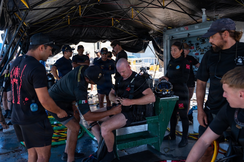 Multinational Clearance Divers conduct a wreck access cutting dive during RIMPAC 2026