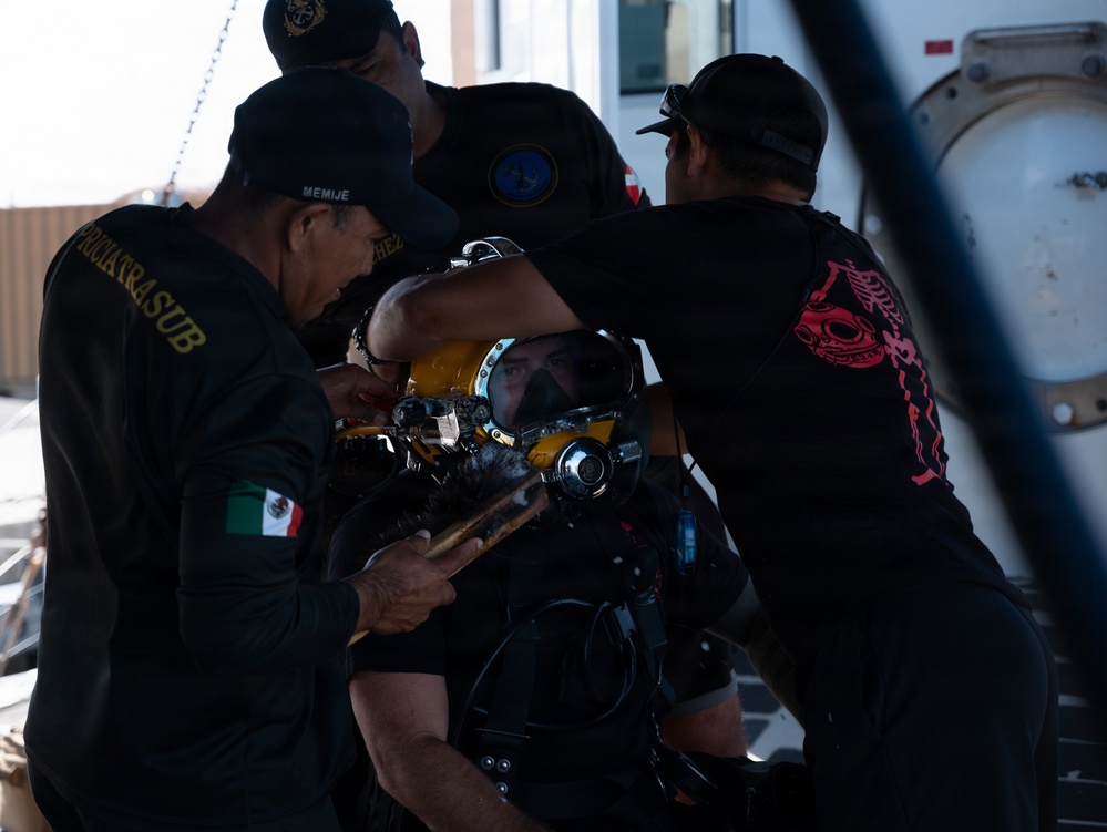 Multinational Clearance Divers conduct a wreck access cutting dive during RIMPAC 2026