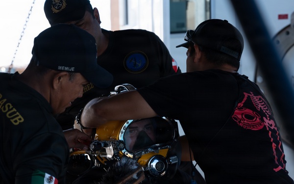 Multinational Clearance Divers conduct a wreck access cutting dive during RIMPAC 2026