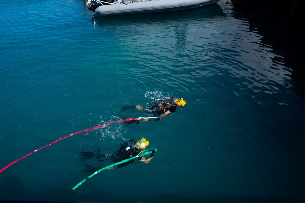 Multinational Clearance Divers conduct a wreck access cutting dive during RIMPAC 2026