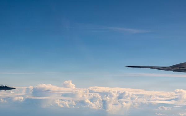 B-2 Stealth Bomber and an F-15E Strike Eagle participate in a live-fire sinking exercise as part of Valiant Shield 2026
