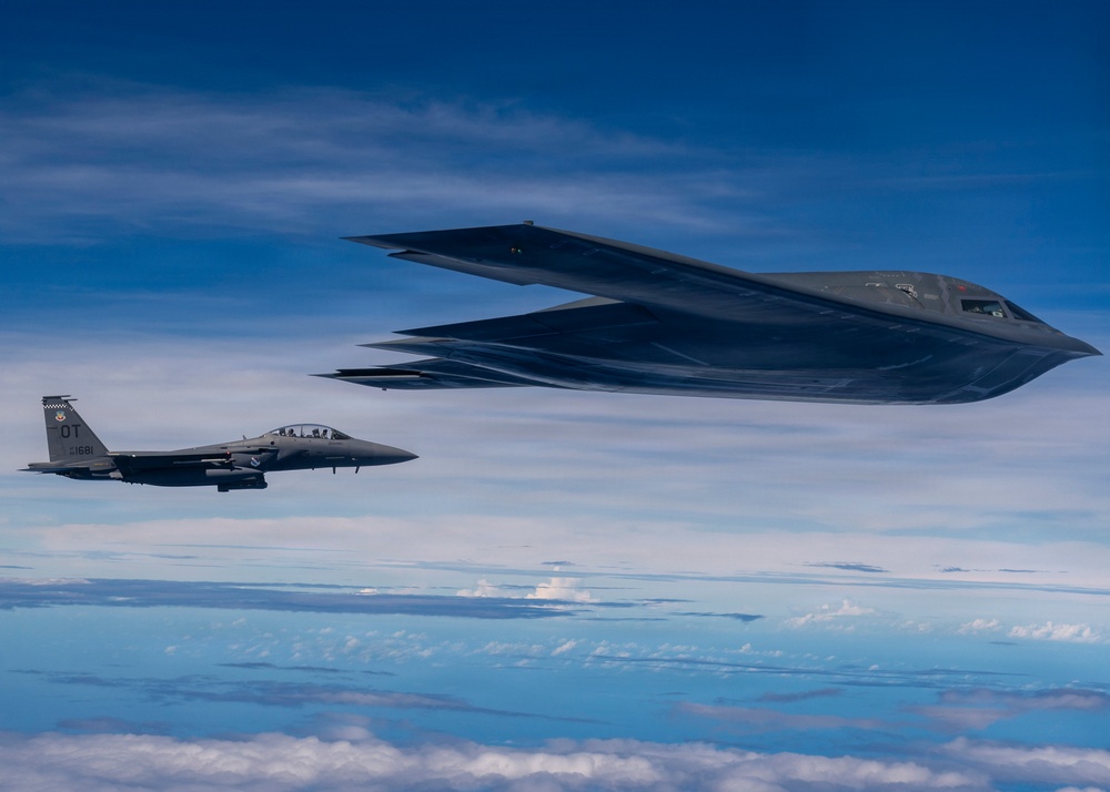 B-2 Stealth Bomber and an F-15E Strike Eagle participate in a live-fire sinking exercise as part of Valiant Shield 2026