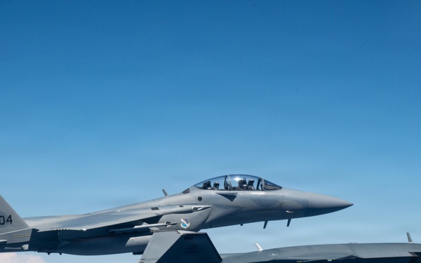 An MQ-28 Ghost Bat from Boeing Defense Australia and a U.S. Air Force F-15EX Eagle II participate in Valiant Shield 2026