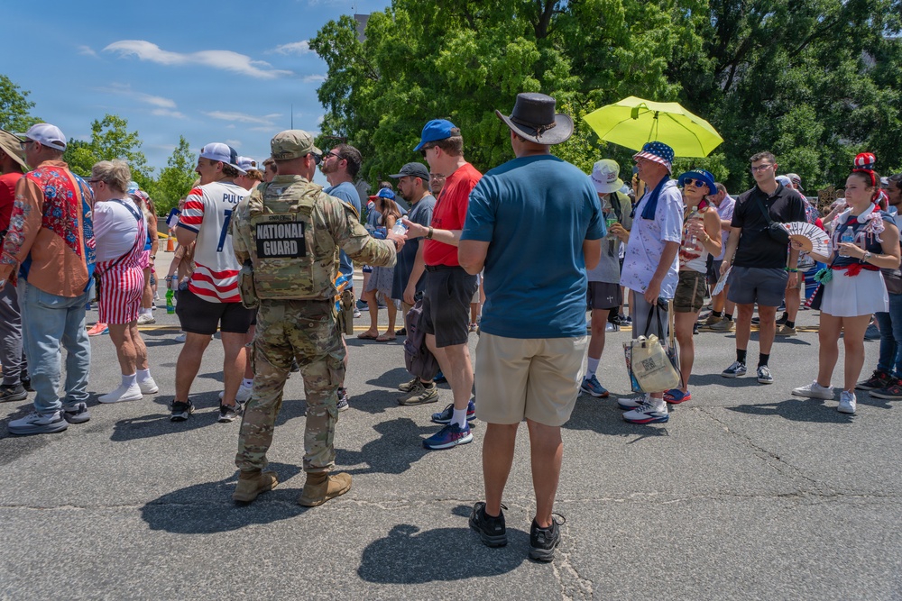 Mississippi National Guardsmen pass out water during America 250 heat wave