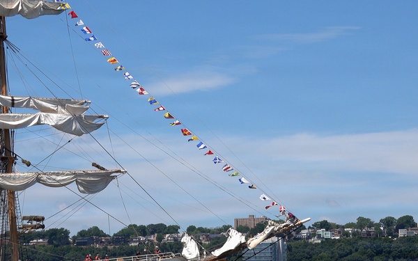 U.S. Coast Guard Cutter Eagle (WIX 327) displays signal flags as it transits the Hudson River near the Royal Moroccan Navy frigate RMNS Mohammed VI (701) during International Naval Review 250
