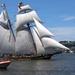 Tall ship Pride of Baltimore II transits the Hudson River during International Naval Review 250 as a U.S. Coast Guard response boat operates nearby and the Royal Moroccan Navy frigate RMNS Mohammed VI (701) is visible in the background
