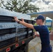 U.S. Coast Guard transports water in concert with damage assessments for port recovery